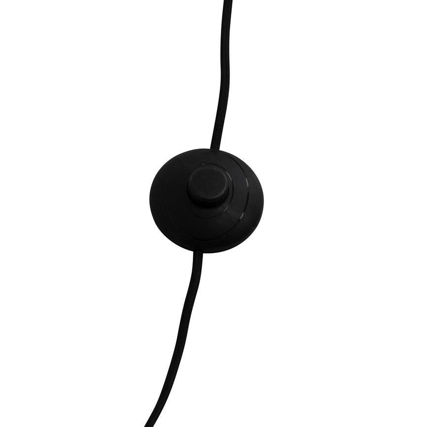 En rund, sort in-line afbryder med central trykknap, monteret på en stofbeklædt ledning, ligger centralt mod en ren, hvid baggrund.