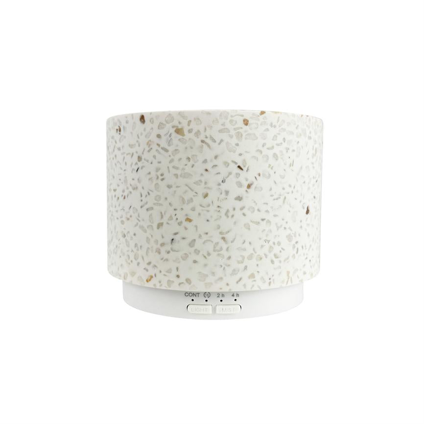 Cylindrisk terrazzo-duftdiffuser — står uden synlig damp — mod en ren, hvid baggrund. Tekst på basen: "CONT 2 h 4 h" og knapperne "LIGHT" og "MIST".